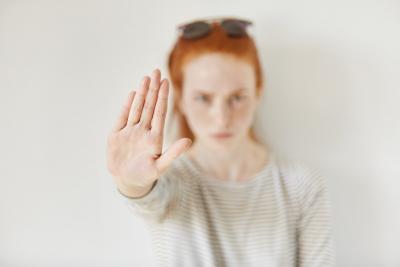 Girl raising her hand to indicate no